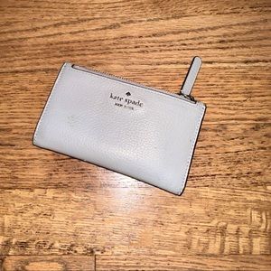 Authentic Kate spade leather bifold wallet in gray. Preloved but no major flaws